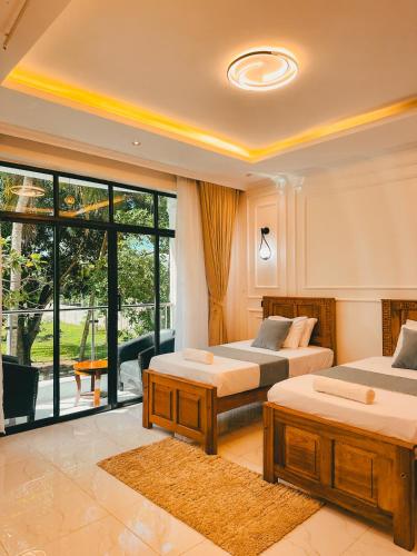 a bedroom with two beds and a balcony at Serian Breeze 6 Bedroom Villa Diani in Ukunda