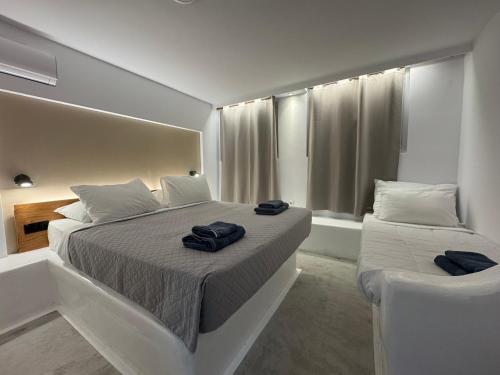 a bedroom with two beds with towels on them at Vista Mare in Naousa