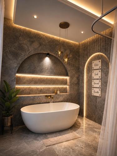 a bathroom with a tub and a stone wall at Rivora Villa in Nashik
