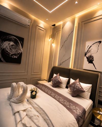 a bedroom with a bed with a swan made up at Rivora Villa in Nashik
