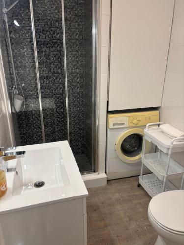 a bathroom with a shower and a toilet and a sink at Rochavaumar in Portimão