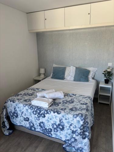 a bedroom with a bed with towels on it at Rochavaumar in Portimão