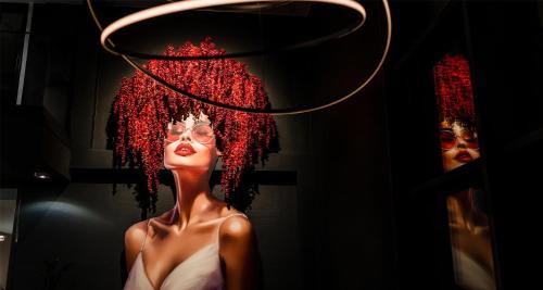 a mannequin with red hair and glasses in a window at Aiden by Best Western Velbert in Velbert