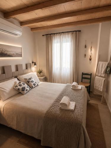 a bedroom with a large bed with towels on it at TorreParadiso Holidays in Polignano a Mare