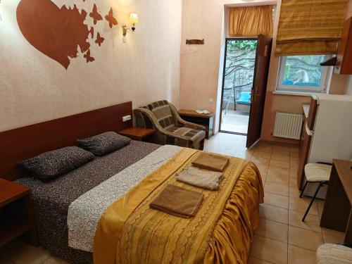 a hotel room with a bed and a living room at Shellman Apart Hotel in Odesa