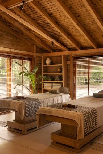 two beds in a large room with windows at Ahama - Relais & Châteaux in Fethiye