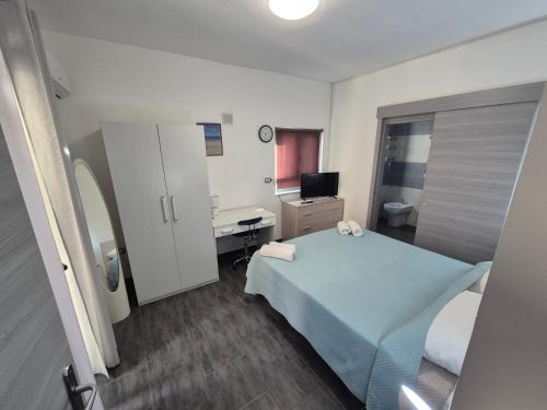 a bedroom with a bed and a desk and a computer at Piazza Salotto in Corigliano Calabro