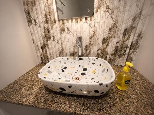 a bathroom sink with a polka dot sink at Hotel Bhagirath Palace in Ahraurā Road