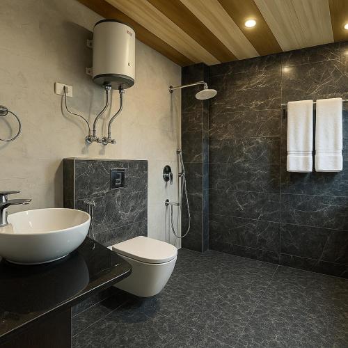 a bathroom with a sink and a toilet and a shower at The Manali Suites & Villas, Manali - Luxury Stay Away From City Hustle in Manāli