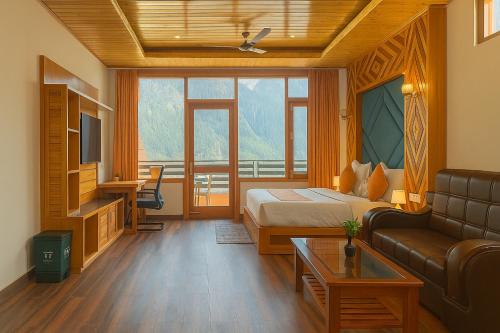 a living room with a bed and a couch at The Manali Suites & Villas, Manali - Luxury Stay Away From City Hustle in Manāli