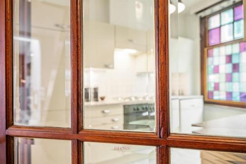 a view of a kitchen through a glass window at Parkhuisje by BLOSS in Bruges
