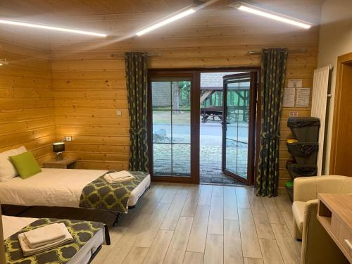 a bedroom with two beds and a sliding glass door at Pod Grzybkiem in Zawady