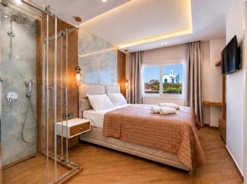 a bedroom with a large bed and a shower at Vista Maris Suites in Amoopi
