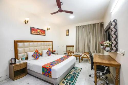 a hotel room with a bed and a desk at FabHotel The Lalit Vibes - Nr DLF Phase 2 & MG Road Metro in Gurgaon