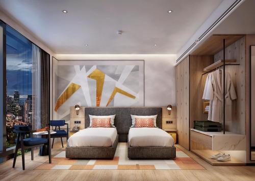 a bedroom with a bed and a desk and a window at Ibis Bangkok Siam Ratchathewi in Bangkok