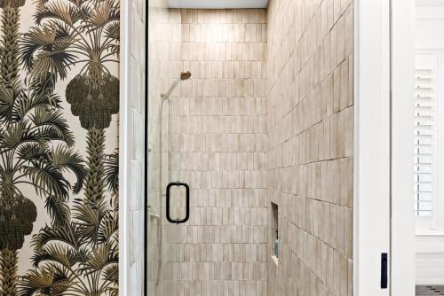 a shower in a bathroom with a tile wall at Luv U Honey in Santa Rosa Beach