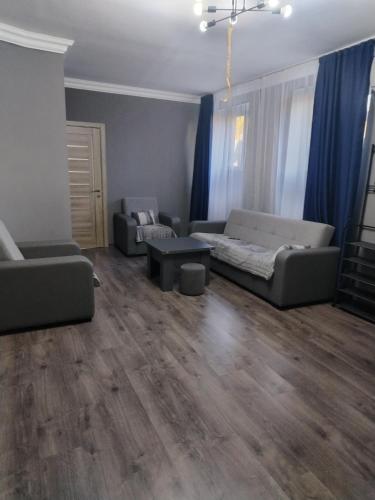 a living room with a couch and a table at Guest House in Garni