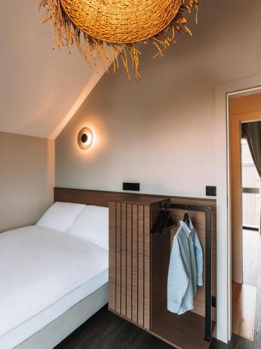 a bedroom with a bed and a mirror at Palmera in Władysławowo