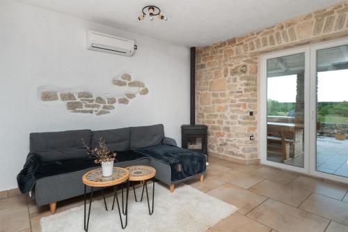 a living room with a couch and a table at House Toma in Oklaj