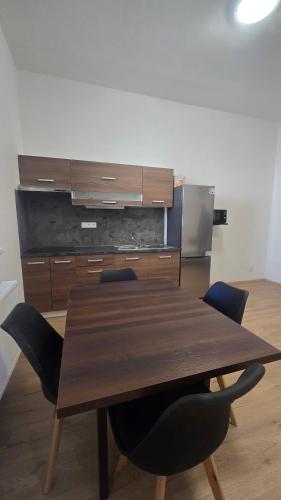 a wooden table in a room with chairs around it at Ubytovna Chropyně in Kroměříž