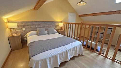 a bedroom with a large bed in a room at Sous les serves in Saint-Léonard-de-Noblat