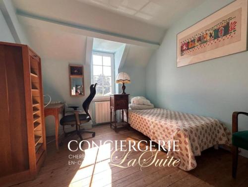a bedroom with a bed and a desk and a window at Le Nid du Matelot in Saint-Vaast-la-Hougue