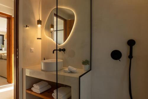 a bathroom with a sink and a mirror at NeRó Villas Lefkada in Tsoukalades
