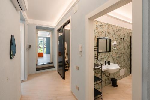 a bathroom with a sink and a mirror at Parmenide Family Apartment in Ascea