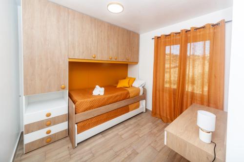 a small bedroom with a bed and a wooden cabinet at Dream Houses in Marina di Palma