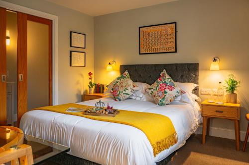 a bedroom with a large bed with a yellow blanket at Crown & Punchbowl in Cambridge