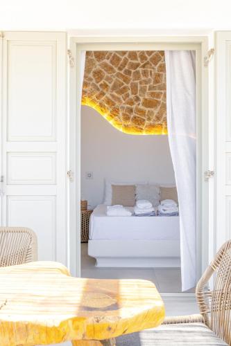 a living room with a bed and a table at Nevo Mykonos in Mikonos