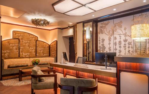 a hotel room with a reception desk and a bed at Hôtel La Bourdonnais by Inwood Hotels in Paris