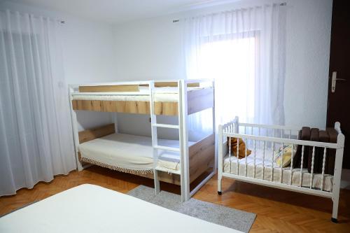 two bunk beds in a room with a window at Sokolovic STD in Lapotince
