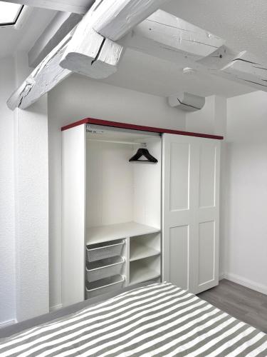 an empty closet with a white door in a room at Brauhaus Suite 19 in Sebnitz