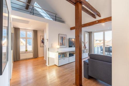 a living room with a couch and some windows at Wohnung Strand Vier in Borkum