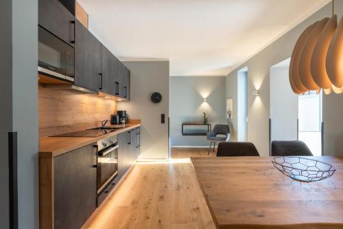 a kitchen with a wooden counter top and a table at Ferienwohnung 1 K20 in Borkum