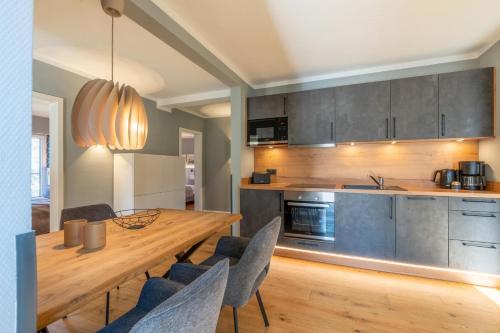 a kitchen with a wooden table and chairs at Ferienwohnung 1 K20 in Borkum