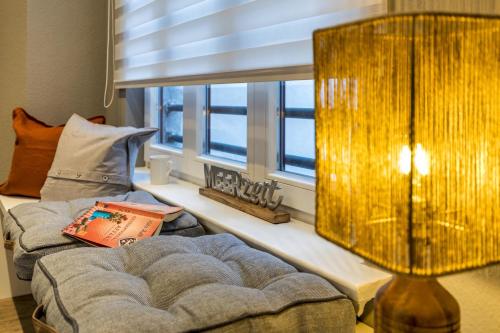 a living room with a couch and a window at Ferienwohnung Eilert in Borkum
