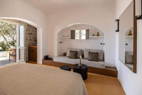 a bedroom with a bed and a couch in a room at Iliana Olive Branch in Adamantas