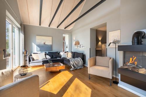 a living room with a couch and a fireplace at Ferienwohnung 2 K20 in Borkum