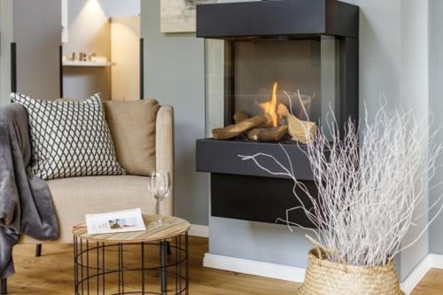 a living room with a couch and a fireplace at Ferienwohnung 2 K20 in Borkum