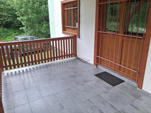 a balcony of a house with two doors at Chata LANOVKA - Vojtechova samota in Spišská Nová Ves