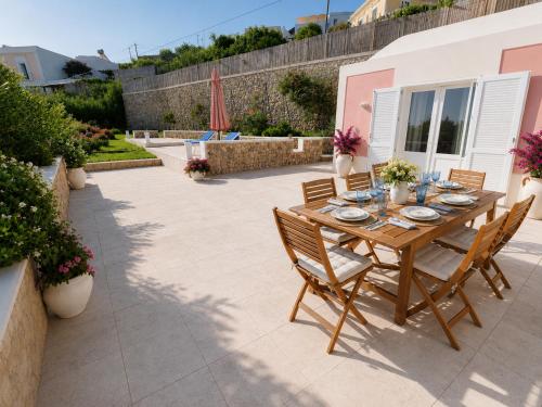 a wooden table and chairs on a patio at Maridea - Villa Alta Marea in Ponza