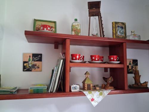 a wooden shelf on a wall with red bowls at Chata LANOVKA - Vojtechova samota in Spišská Nová Ves