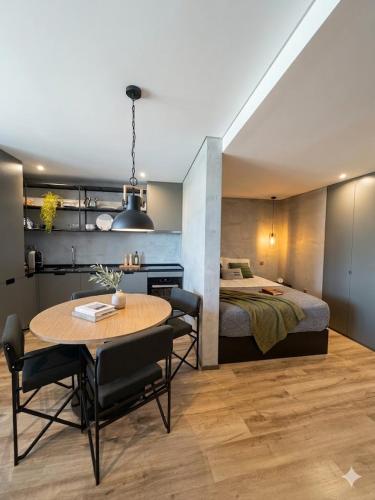 a room with a bed and a table and a bedroom at Fisherman's View in Aveiro