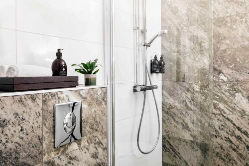 ein Badezimmer mit Dusche und Duschkopf in der Unterkunft Vildmarkshotellet in Kolmården