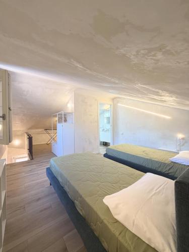 a bedroom with two beds and a refrigerator in it at Casa Historia in Caorle