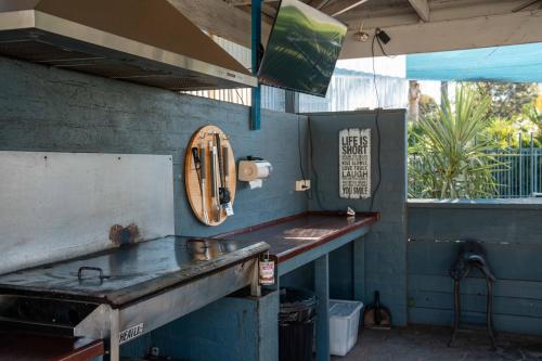 a kitchen with a table and a counter top at Sunrise Motel in Barooga