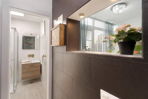a bathroom with a sink and a mirror and a window at Bungalow Sonemar Paradise in Maspalomas