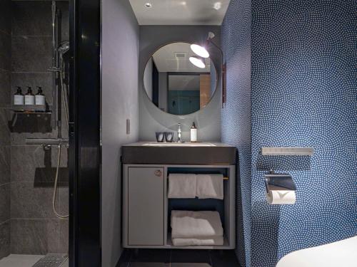 a bathroom with a sink and a mirror at Mercure Kyoto Station in Kyoto